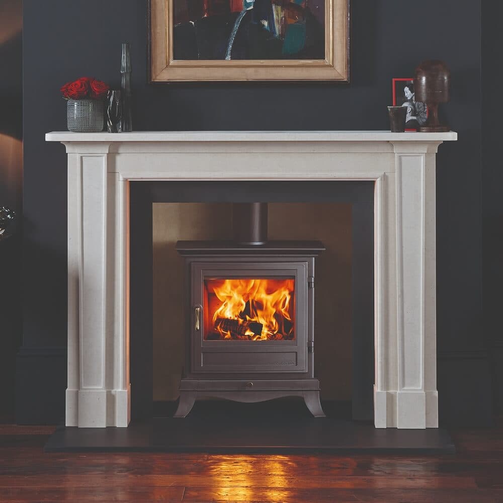 Wood burning stove within a classic white fireplace surround